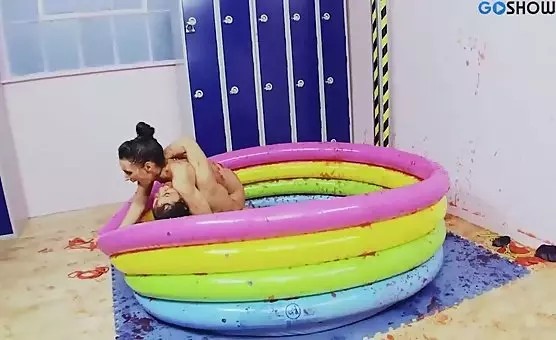 Happy Brunettes Enjoying Red Souce Playtime in Inflatable Pool